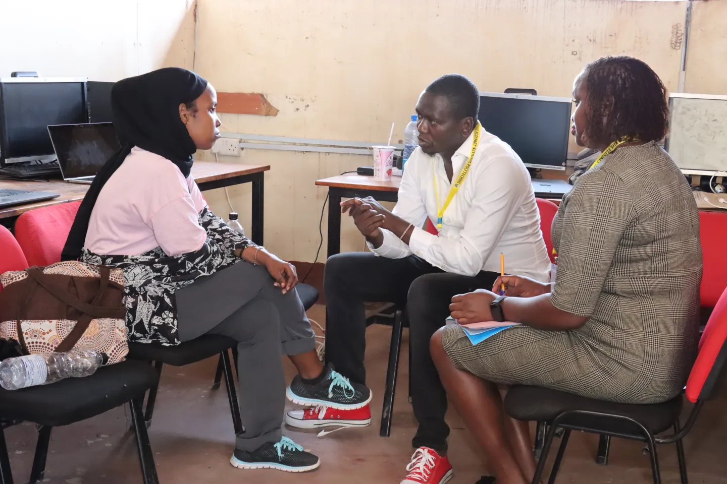 teacher and student in Kenya talking at the computer training centre