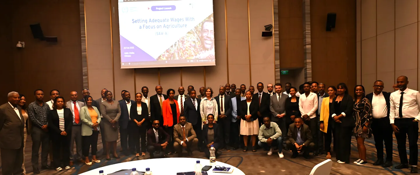 Group of meeting participants posing before a photo