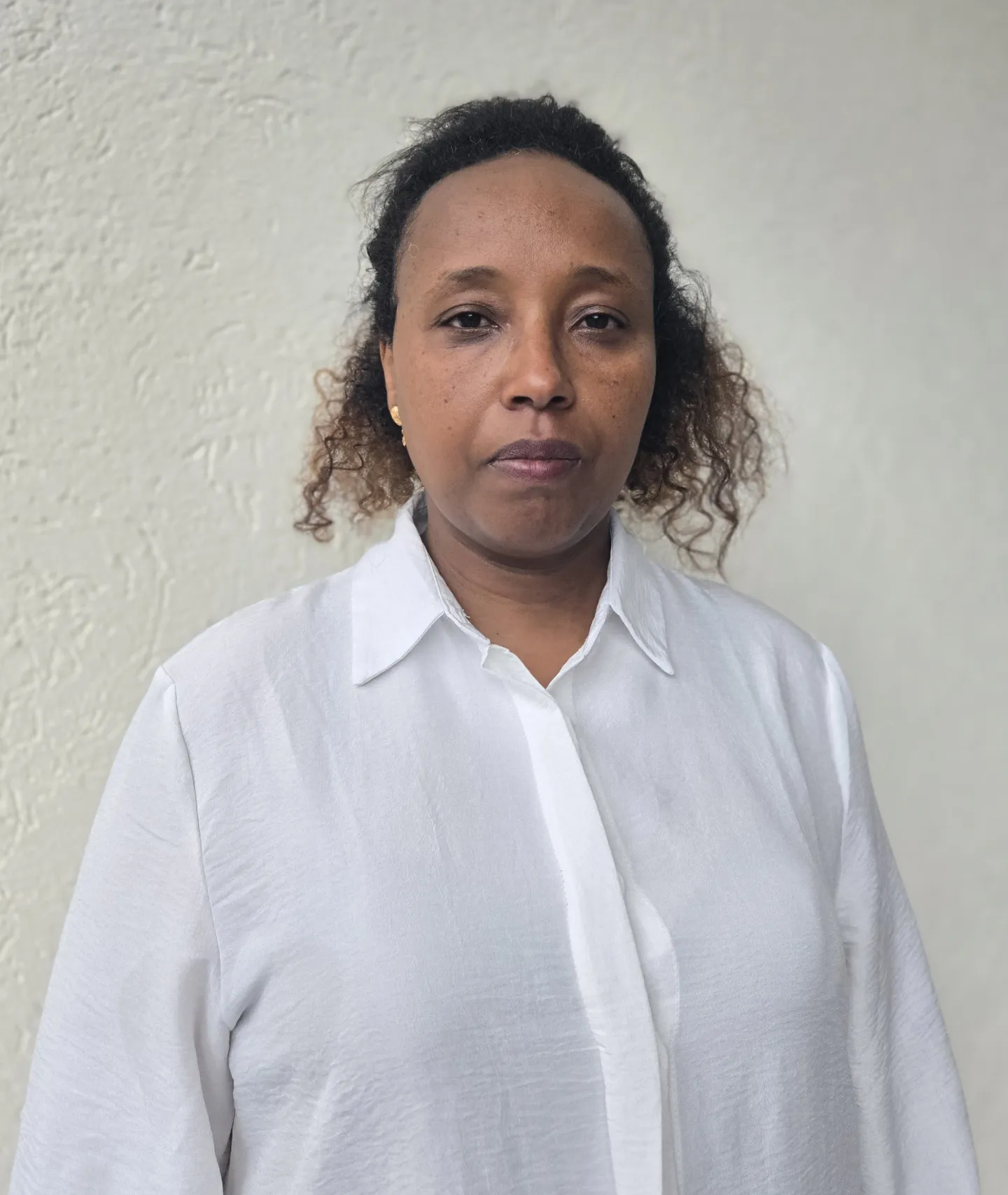 Woman in a swhite shirt posing for a photo