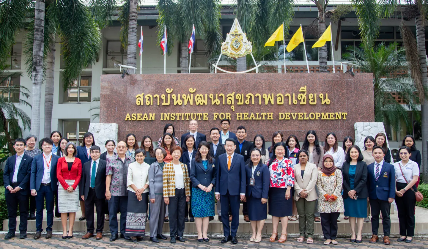 Group photo in front of a sign.