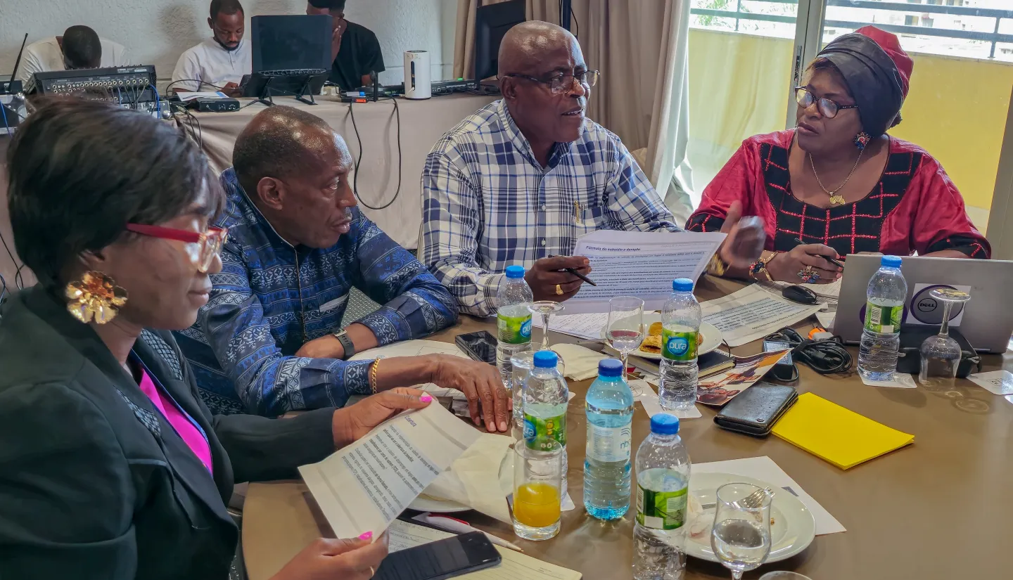 Men and women, from trade unions, in a round table on debate.