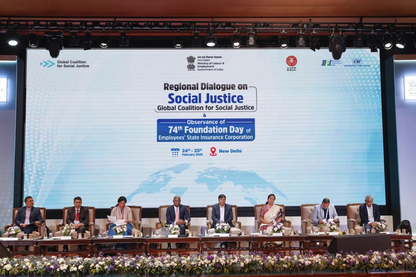 Panel sitting at the dais of an event