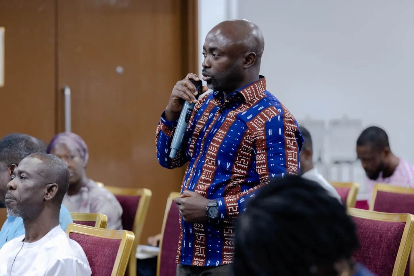 Richard Acheampong from the Trade Union Congress, Ghana is speaking into the microphone from the audience. He is emphasizing the need for a stronger dialogue for better wages.