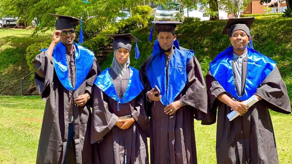 Students wearing graduation gowns during a graduation ceremony at KSTVET