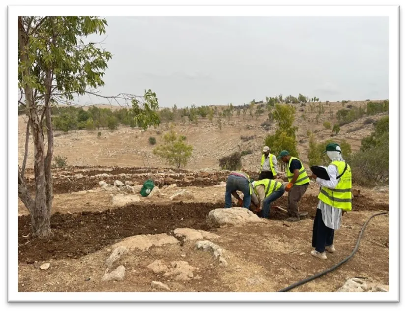 Four workers digging and one woman with a clipboard