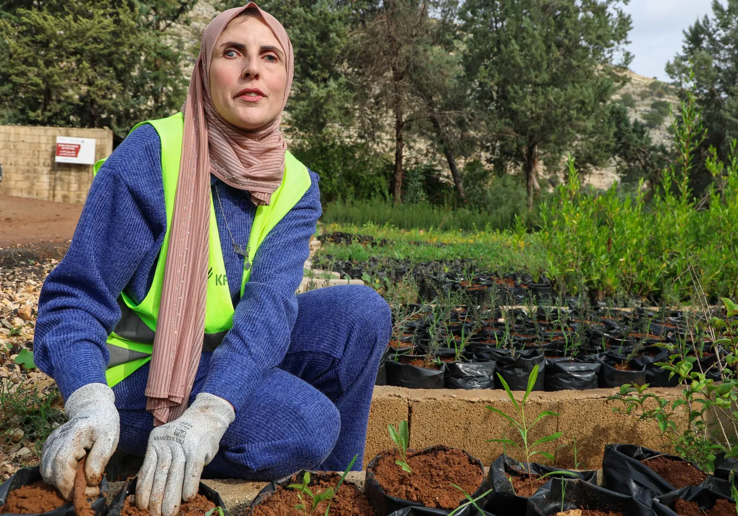 Blind woman working with potted plants