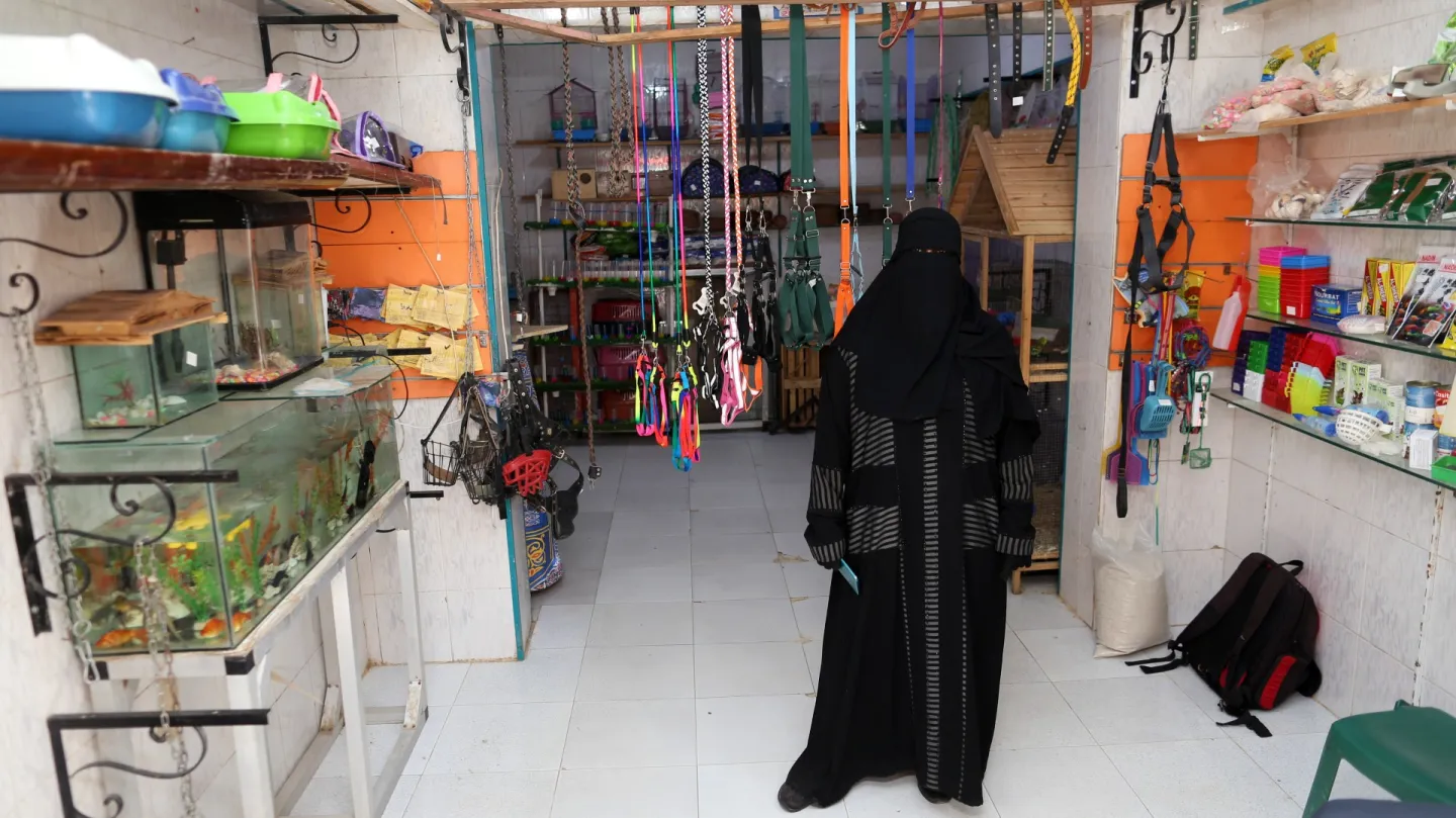 An woman showing the product range from her new business at her pet shop 