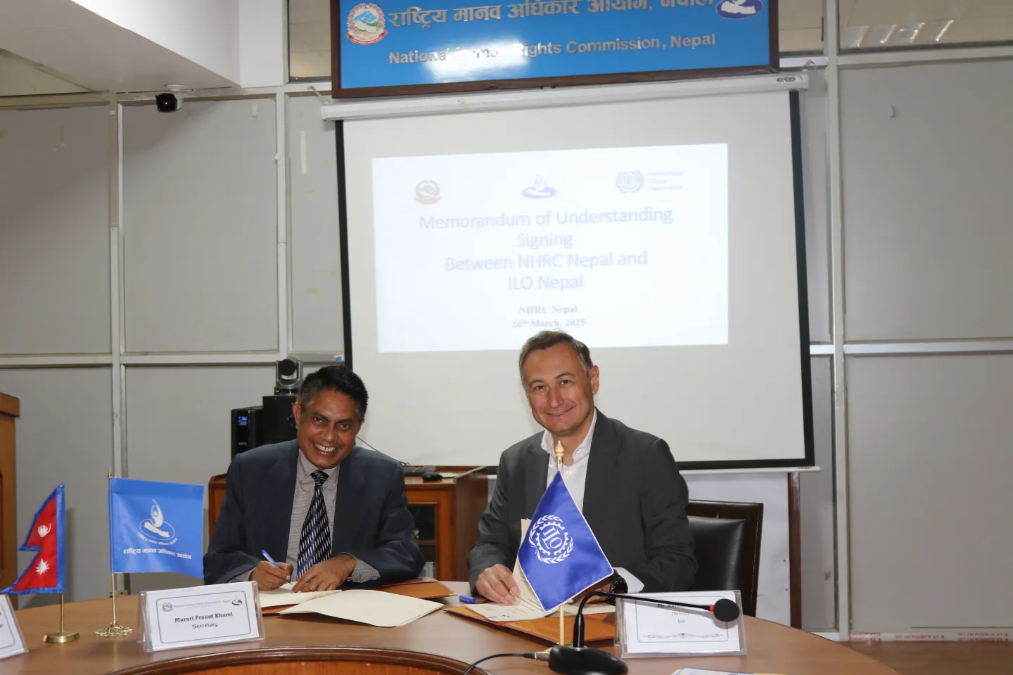 Numan Özcan, Country Director of ILO Nepal, and Mr. Murari Prasad Kharel, Secretary of NHRCN, during the MoU signing ceremony.