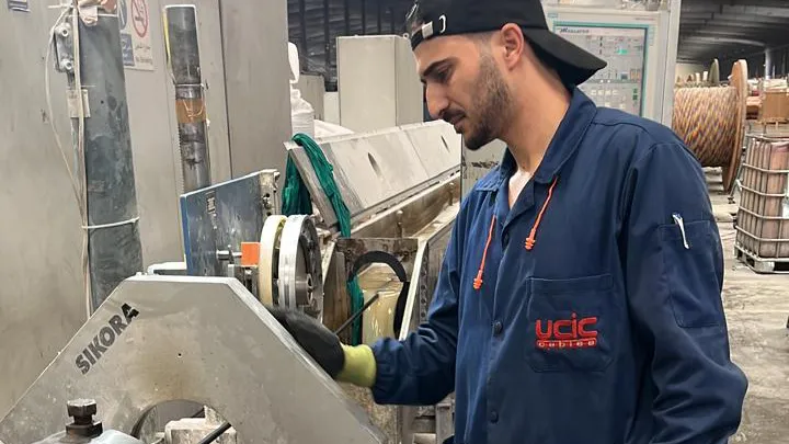 A machine operator in Badiat Al-Sham Company in the filling and packaging section at the plastic plates manufacturing plant