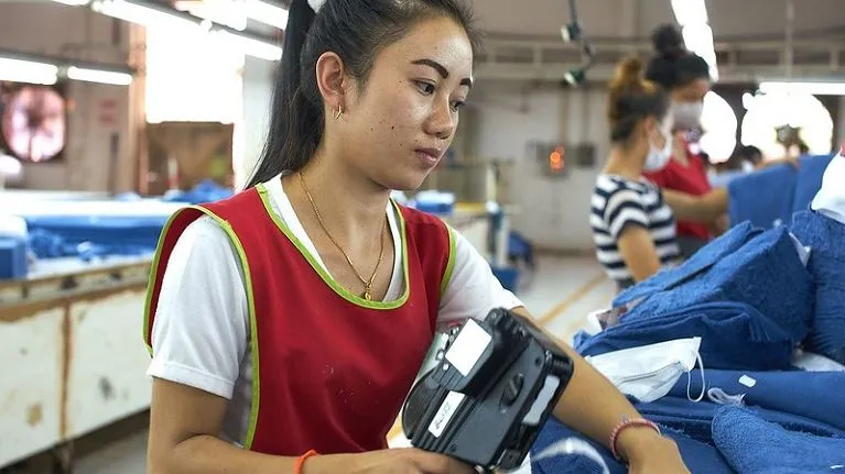 Lao woman worker at a garment factory, Lao People's Democratic Republic.