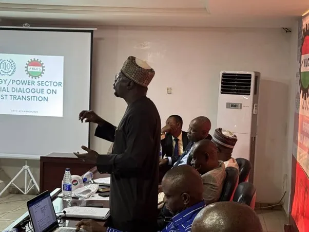 A man making a presentation to participants at a social dialogue