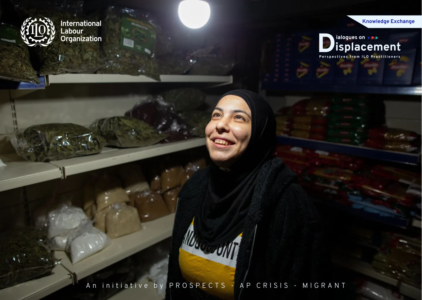 woman standing inside her grocery shop looking at the bulb