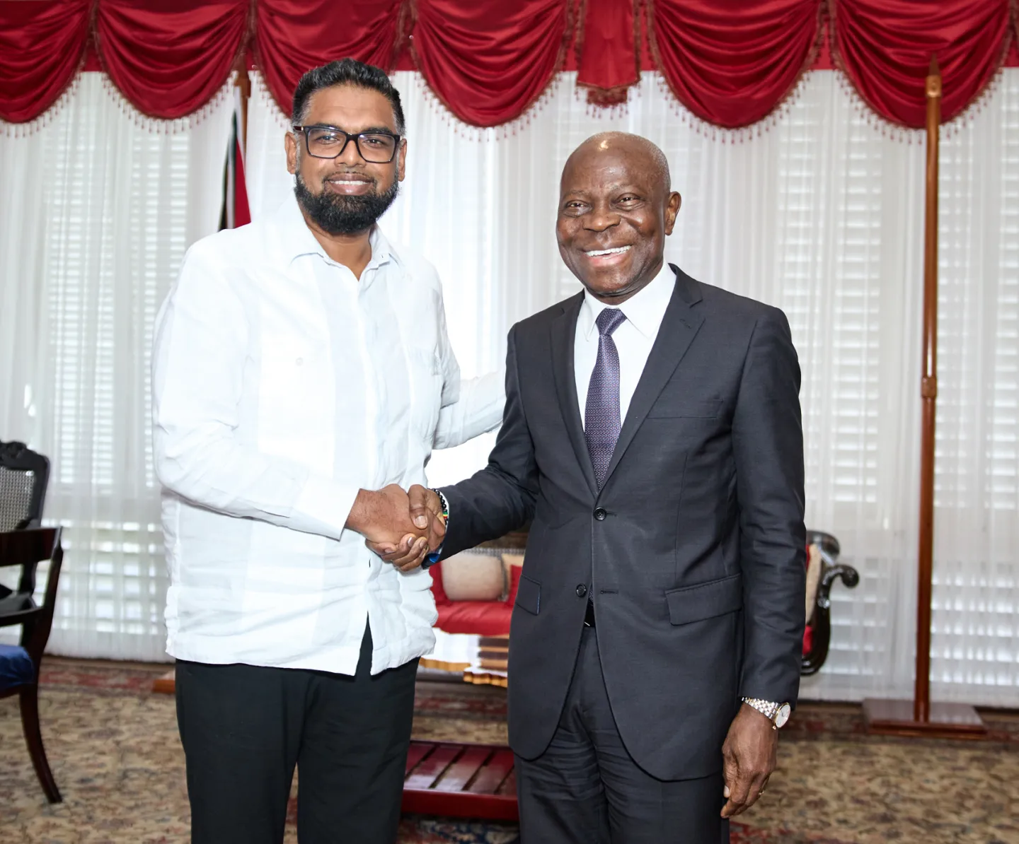 ILO Director-General Gilbert F. Houngbo shakes hands with His Excellency Dr. Mohamed Irfaan Ali, President of Guyana