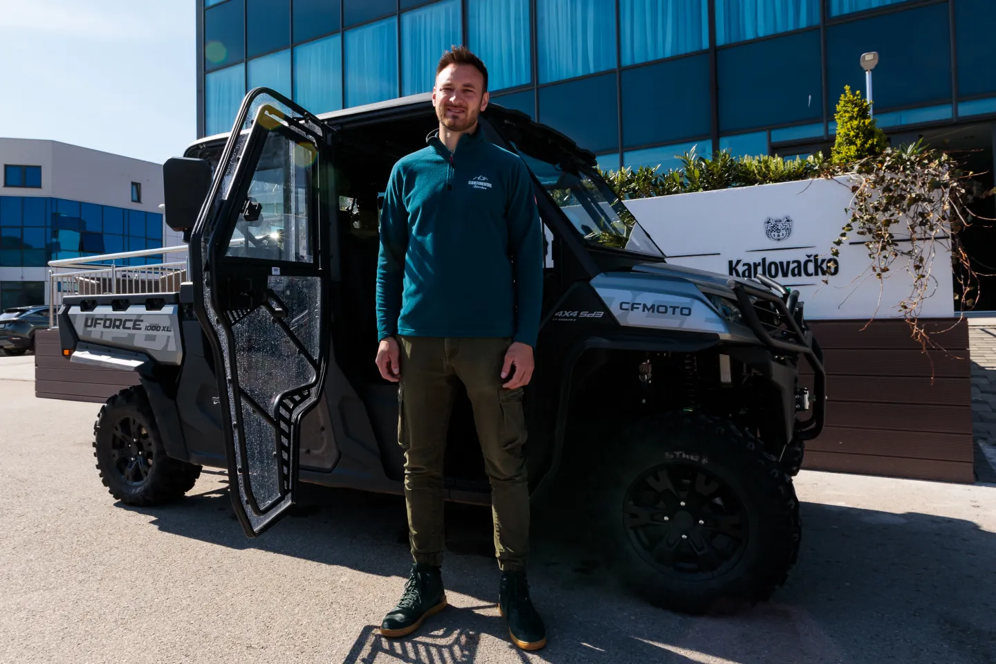 Young man in front of a cross-country vehicle