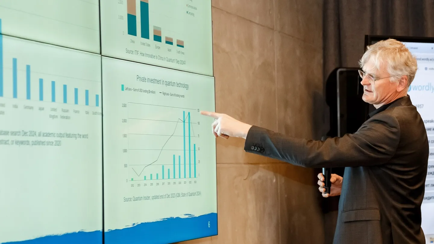 Presenter pointing at a screen