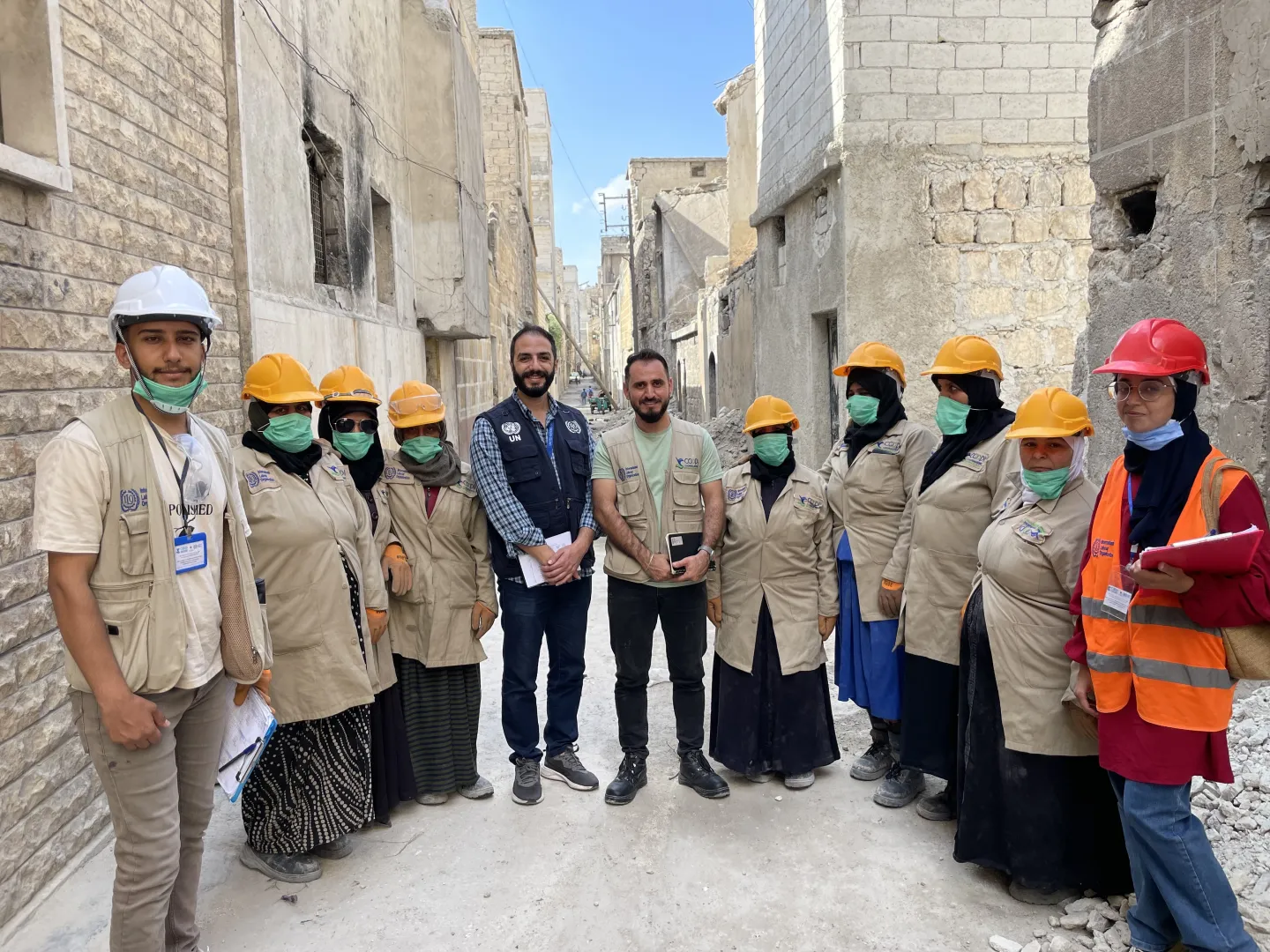 A group of men and women ILO employees in Syria pose for camera