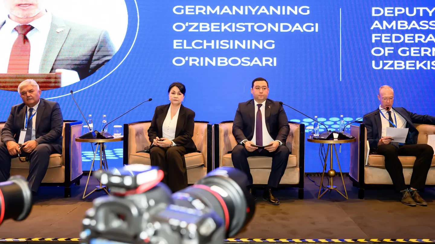 Speakers sitting in chairs in front of the audience