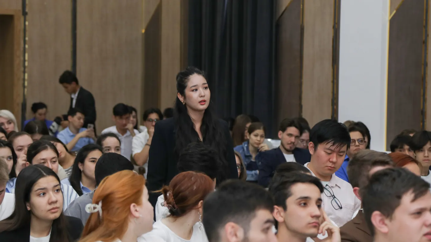 A student standing among a crowd of people