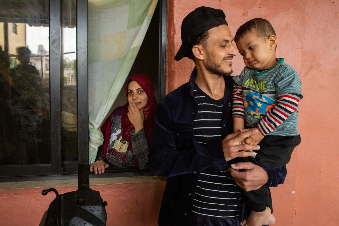 Syrian refugee Mohammad Al-Saf holds his son Khattab