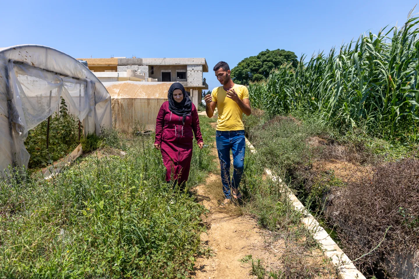 Syrian refugee Fatima Mohammad Kheir Al Zaytoun, 20, speaking with a man