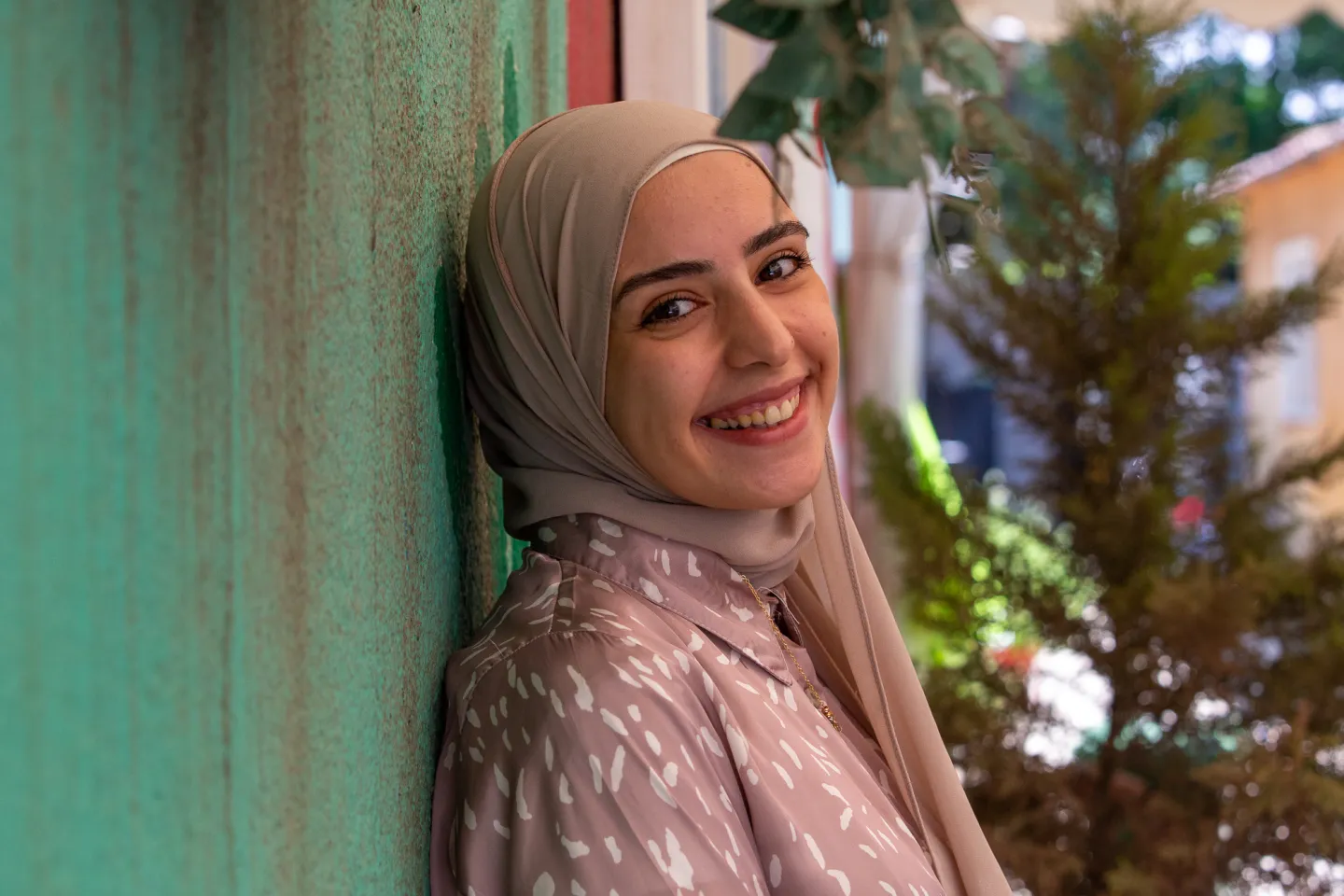 Lebanese woman stands against the wall 