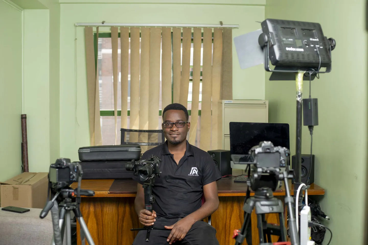 Ignatius in his studio surrounded by his photography and video equipment 