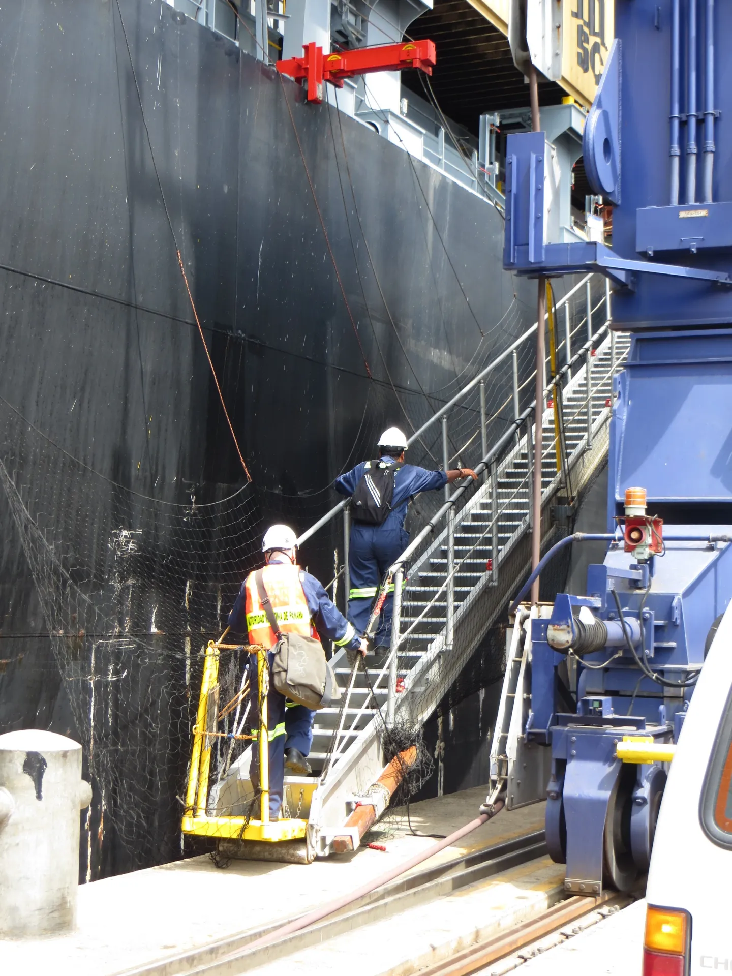 Two labour inspectors are boarding a container ship