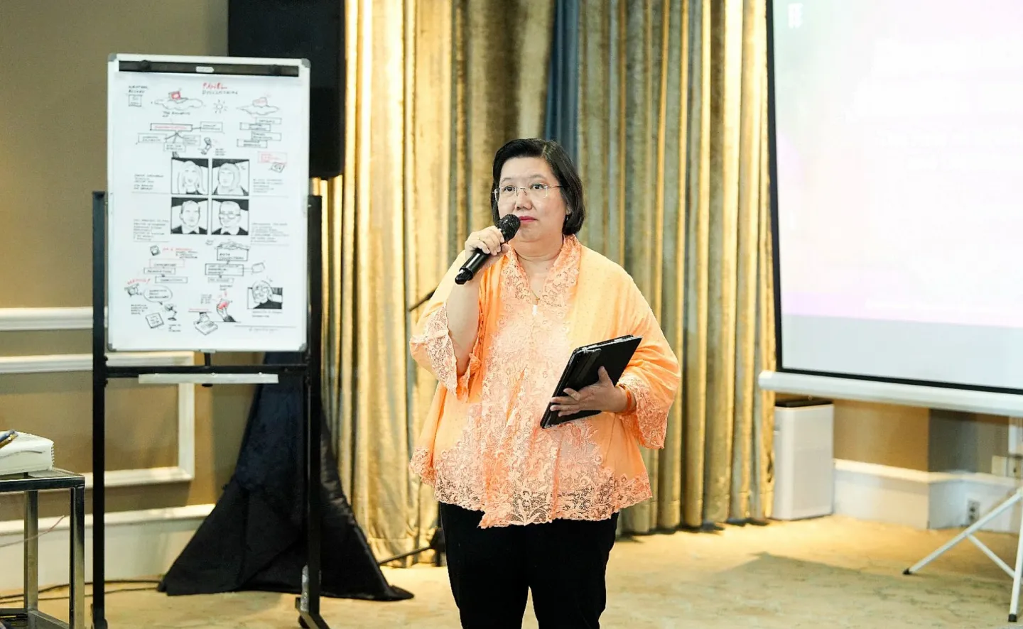 A woman standing holding a microphone