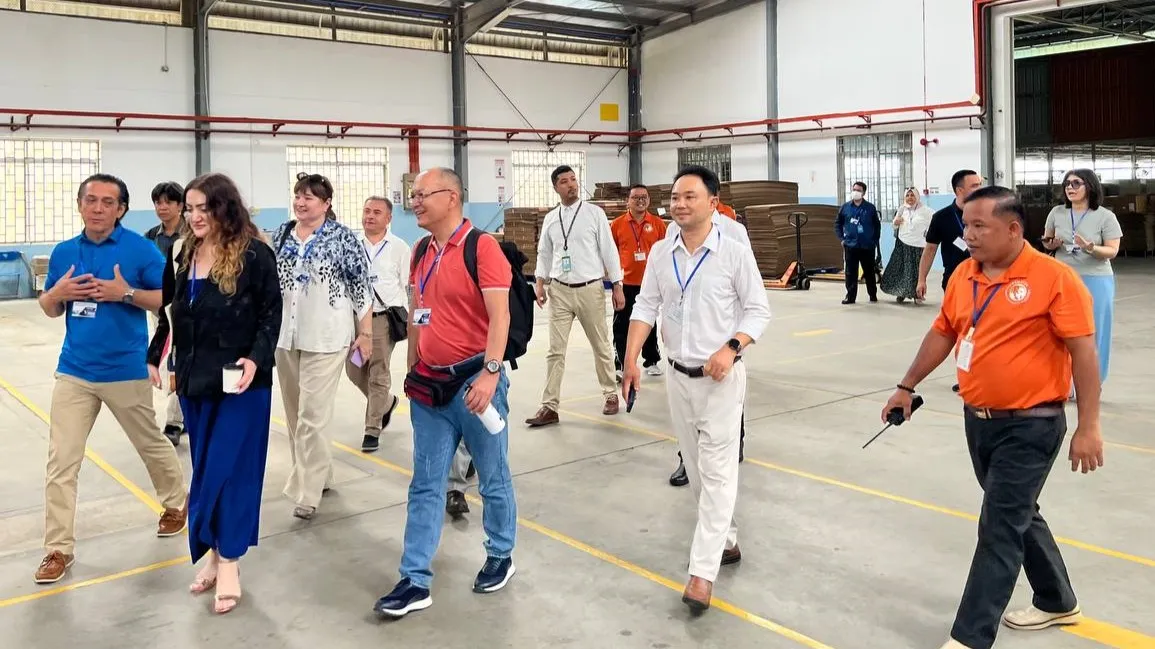 A group of people walking in a room