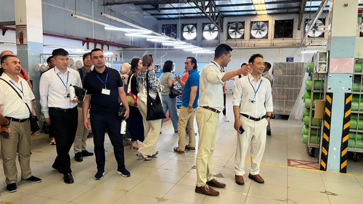 A group of people standing in a production room