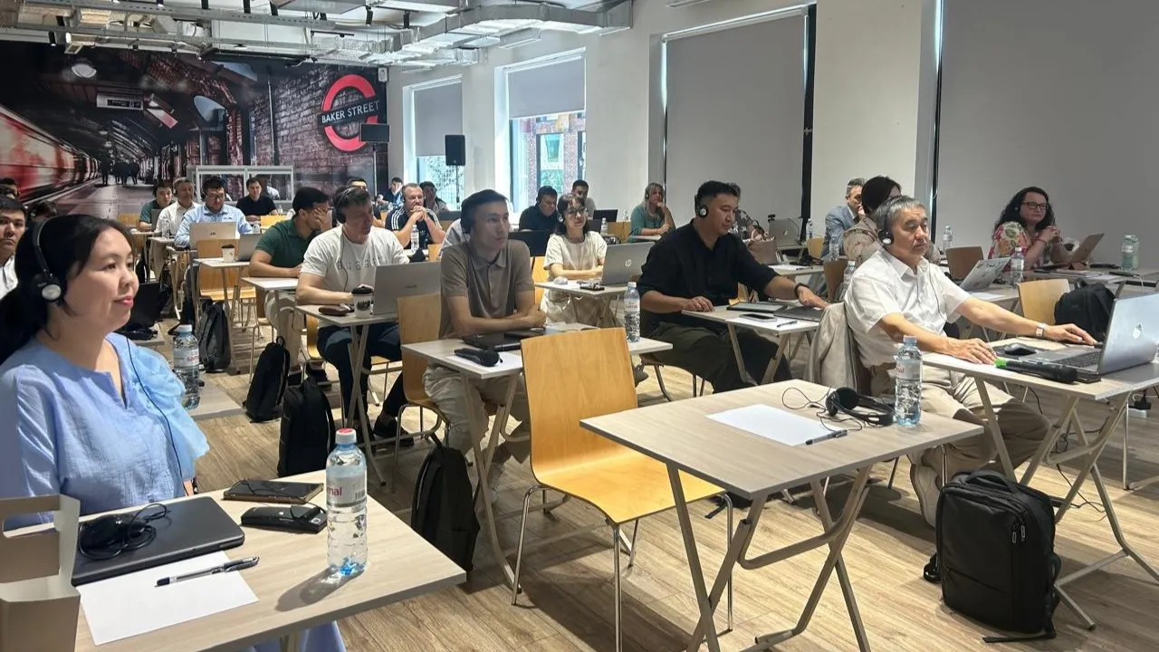A group of people sitting at desks in a room