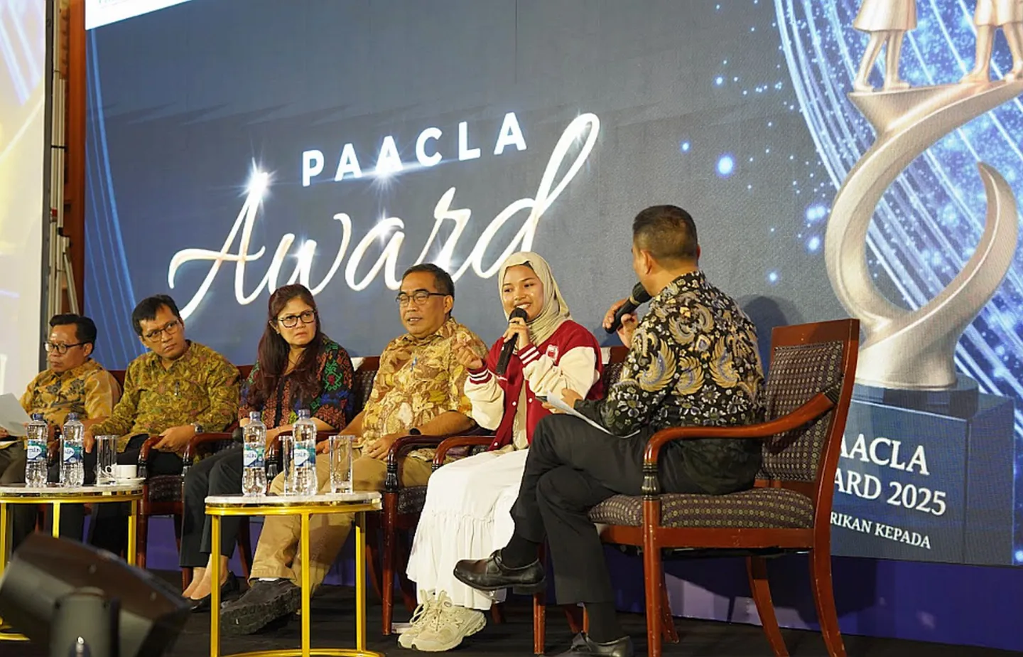 A panel discussion with five people sitting
