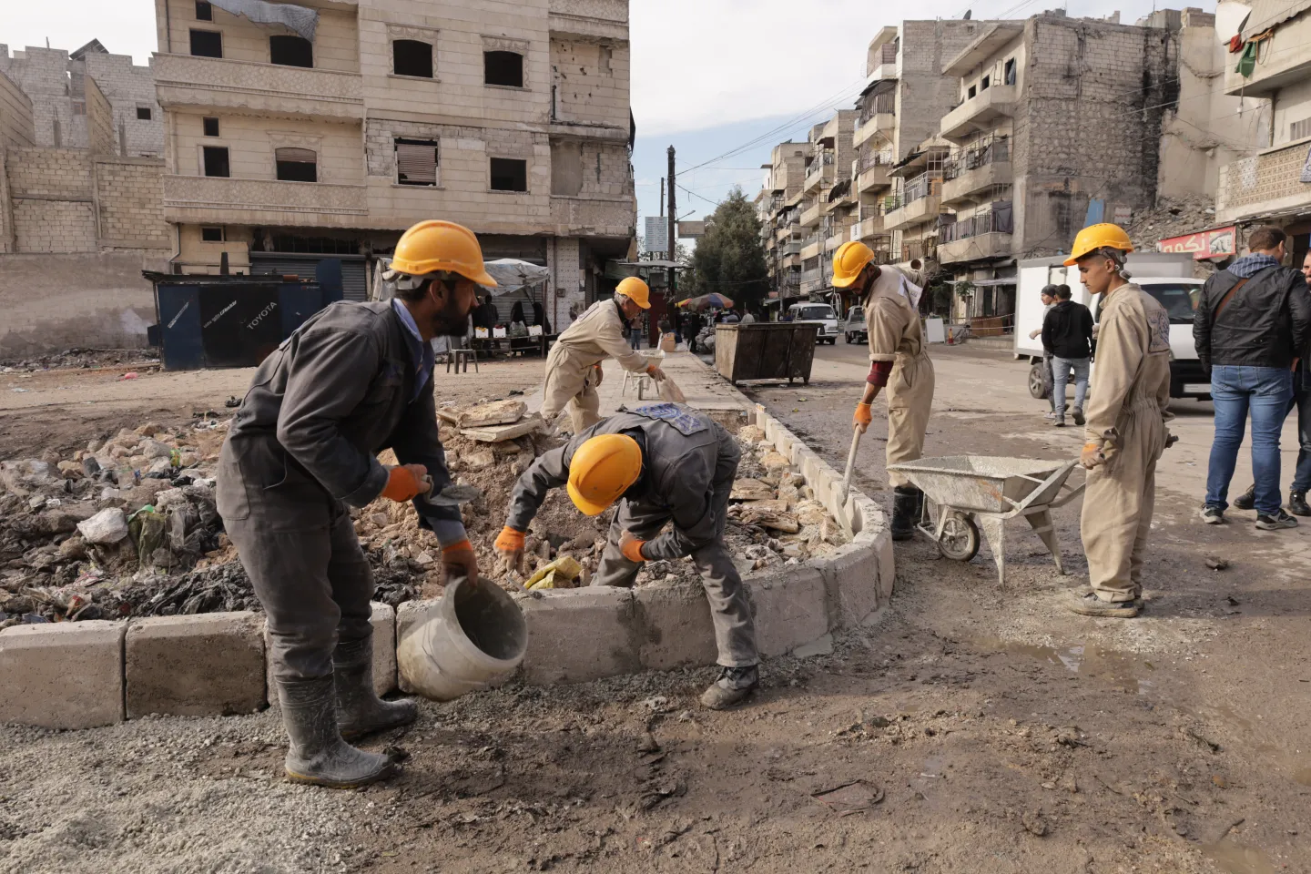 A group of labourers working on a sidewalk rehabilitation work in Syria