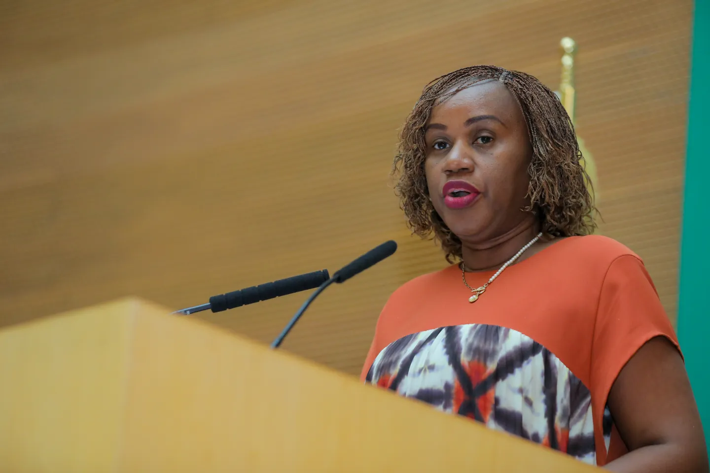 Woman standing at a podium.