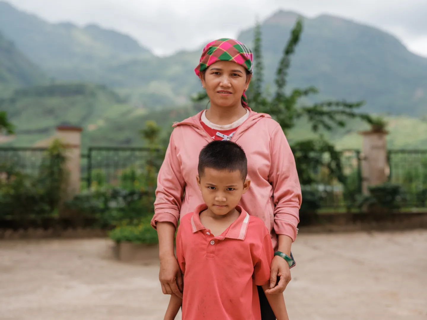 Len Thi Tram, a beneficiary of the Cash for Work programme, and her son, Vang Thu Trang, at the launch of the initiative in Xuan Hoa Commune, Lao Cai province