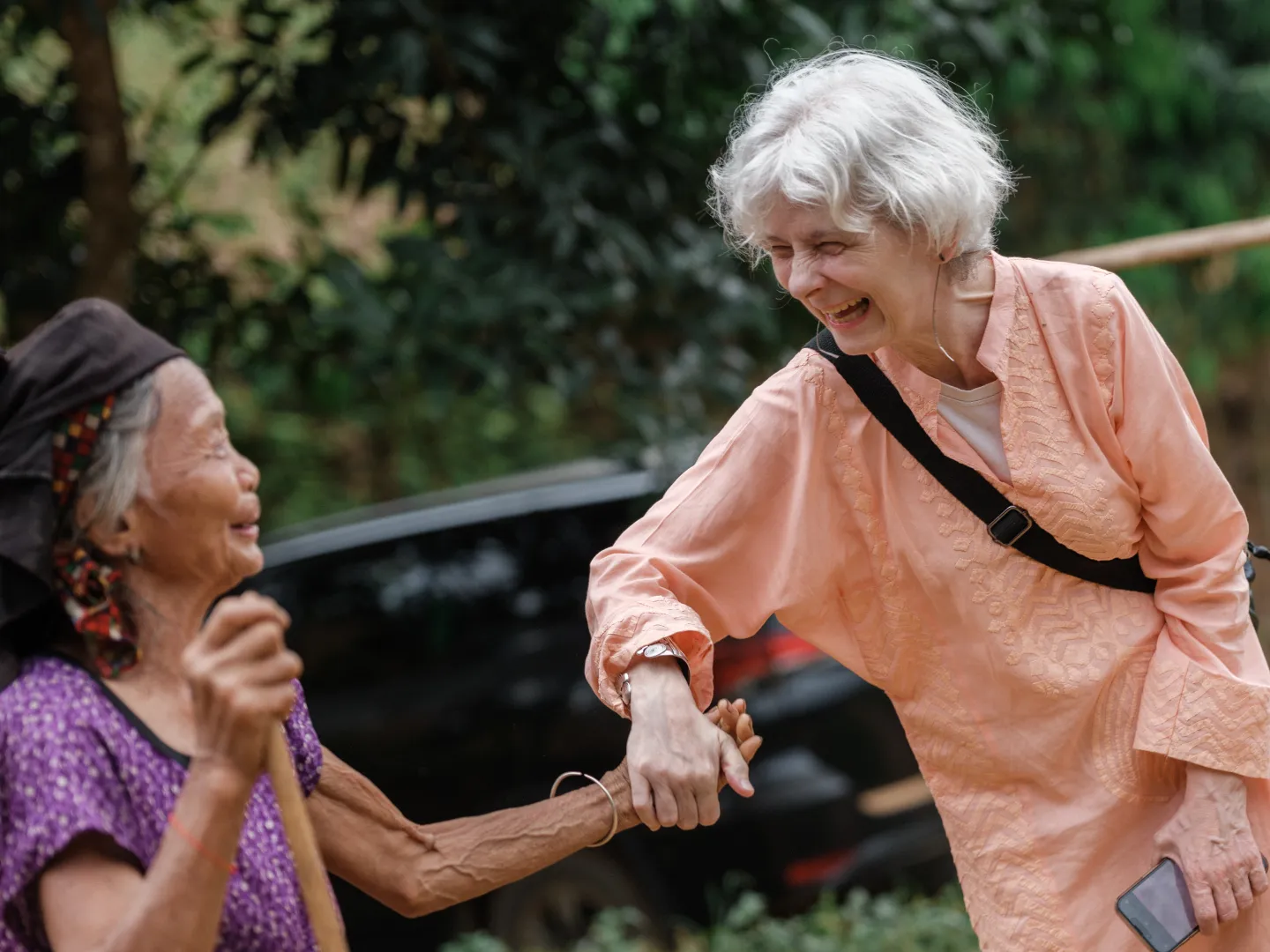 Despite the devastation caused by Typhoon Yagi, Vang Thi Huong warmly greets Ingrid Christensen, Country Director of the ILO in Viet Nam, during a visit to Xuan Hoa Commune - a moment marked by shared smiles and solidarity.