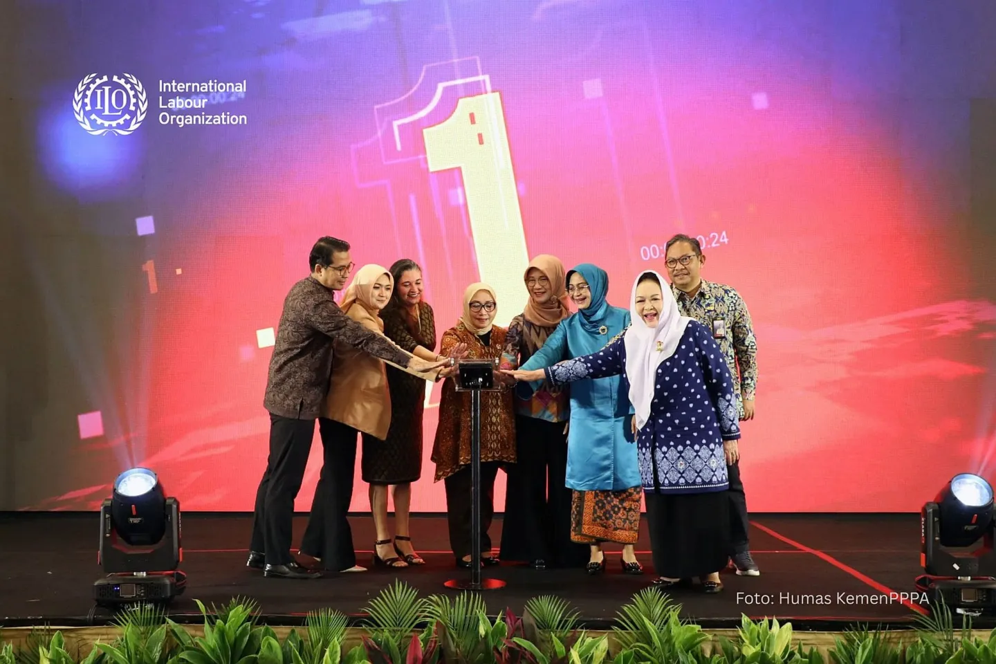 Eight people standing on the stage