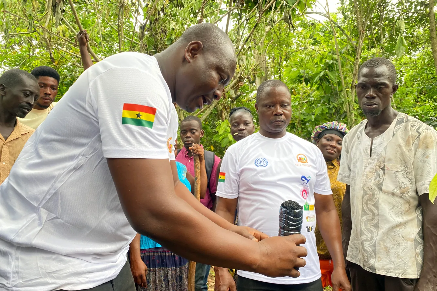 Partners from the Bonso Cocoa College in Ghana teaching farmers how to prepare cocoa seedlings with biochar