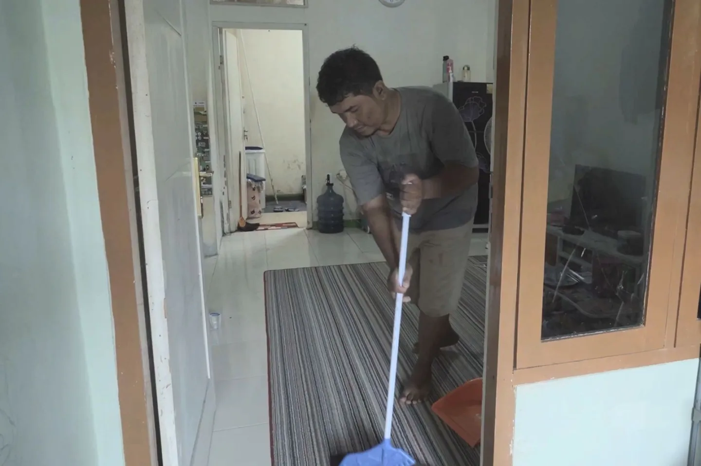 A man holding a broom