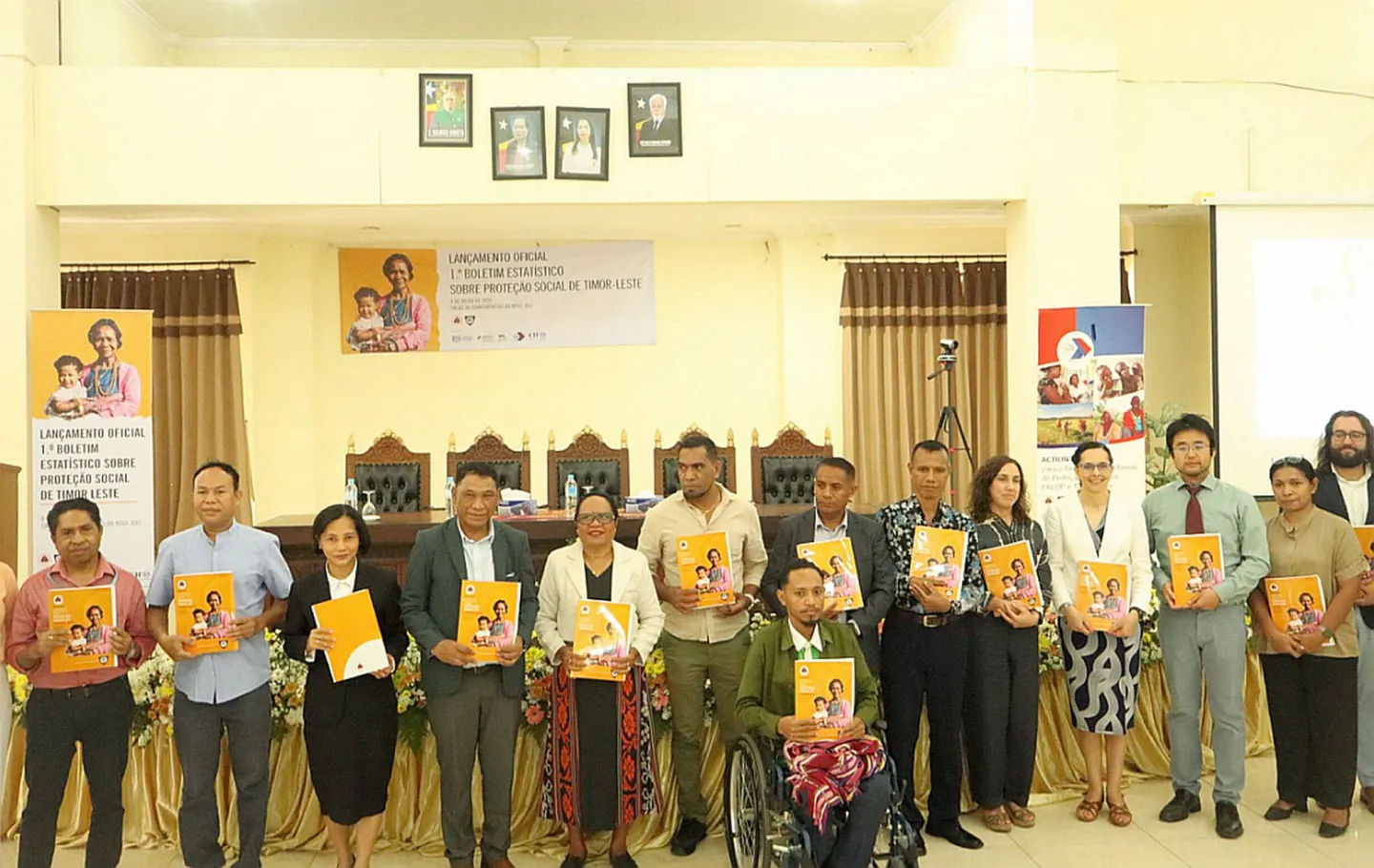 People standing and holding a book