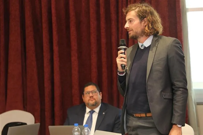 Man in a suit speaking with a microphone