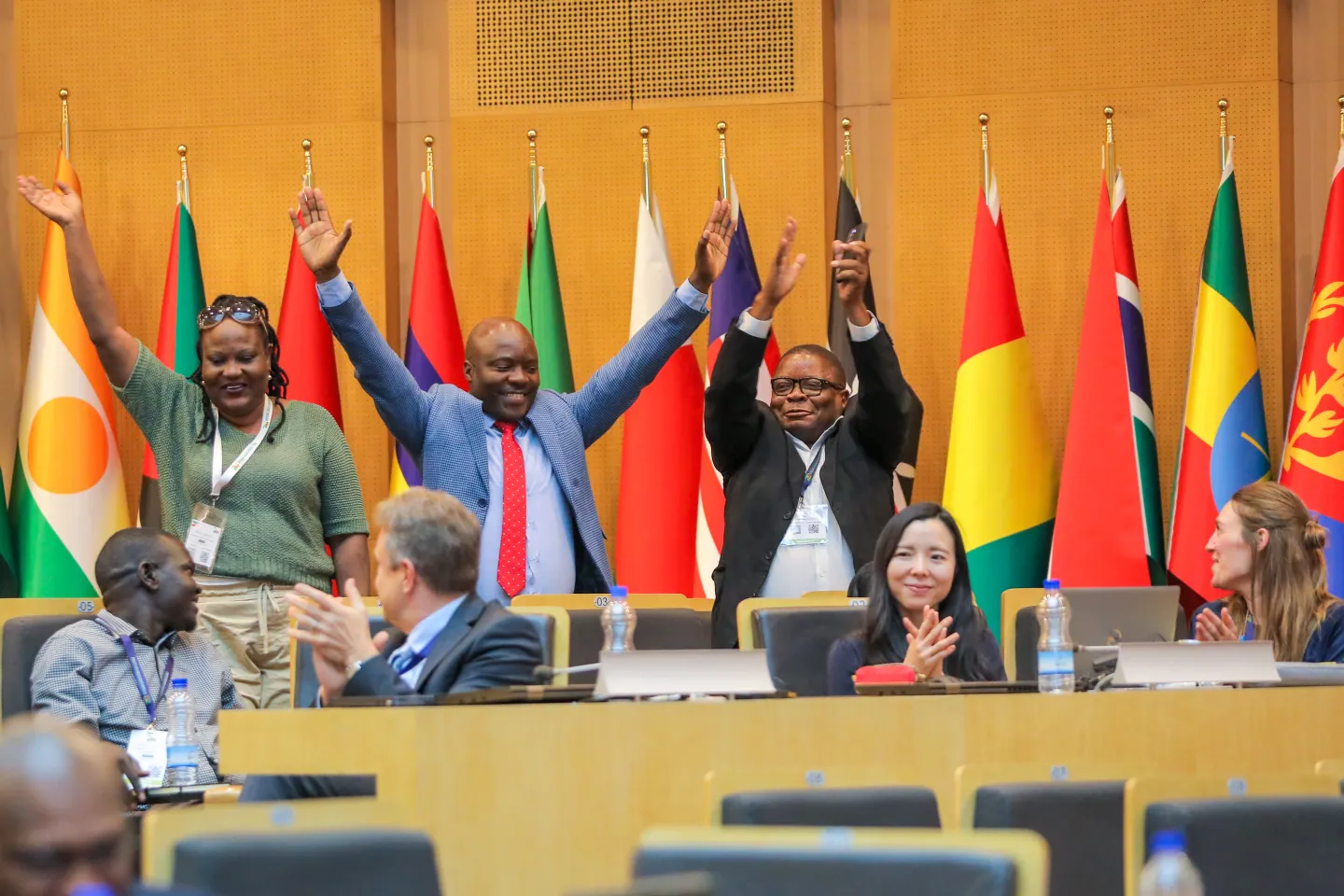 Three people standing and cheering