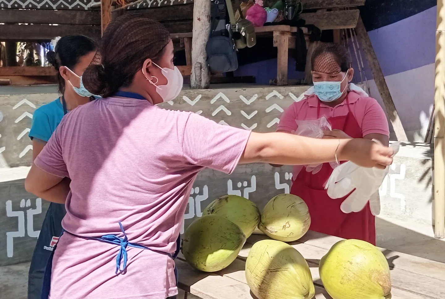 Jonalyn prepares coconuts for cooking.