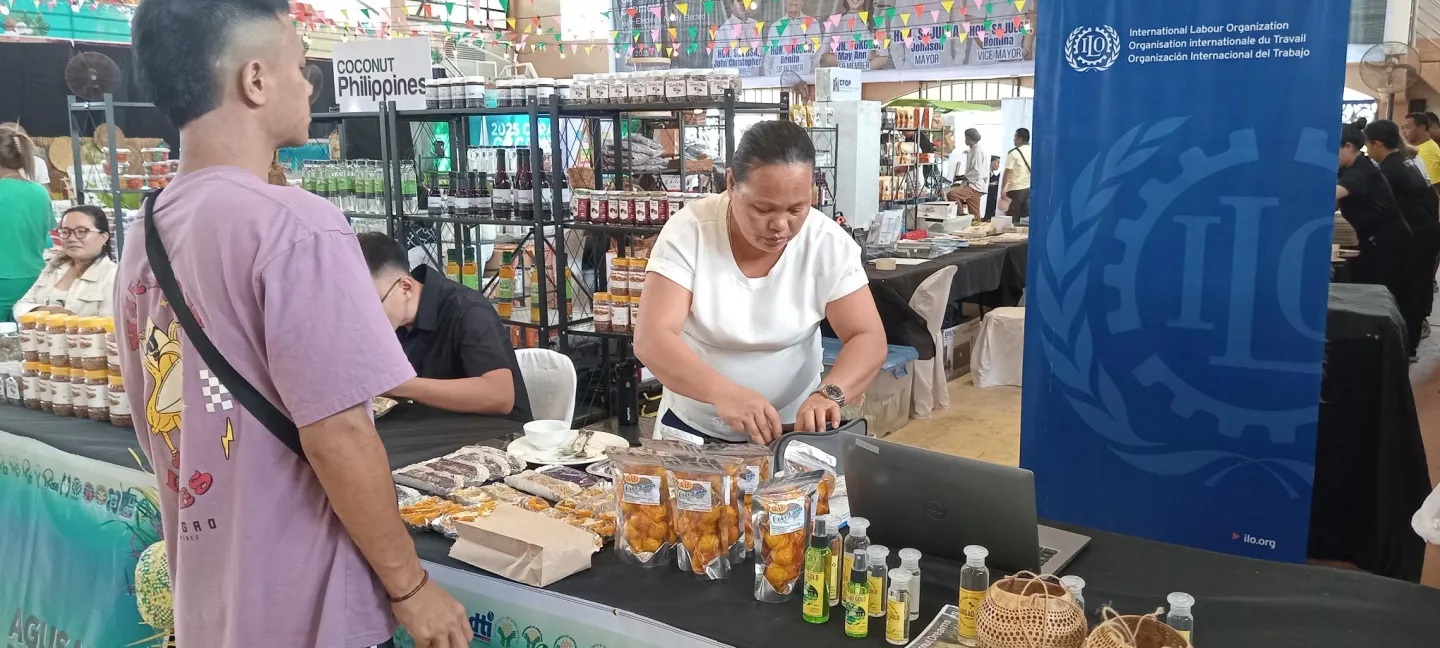 a woman sells coconut-based products at the trade fair