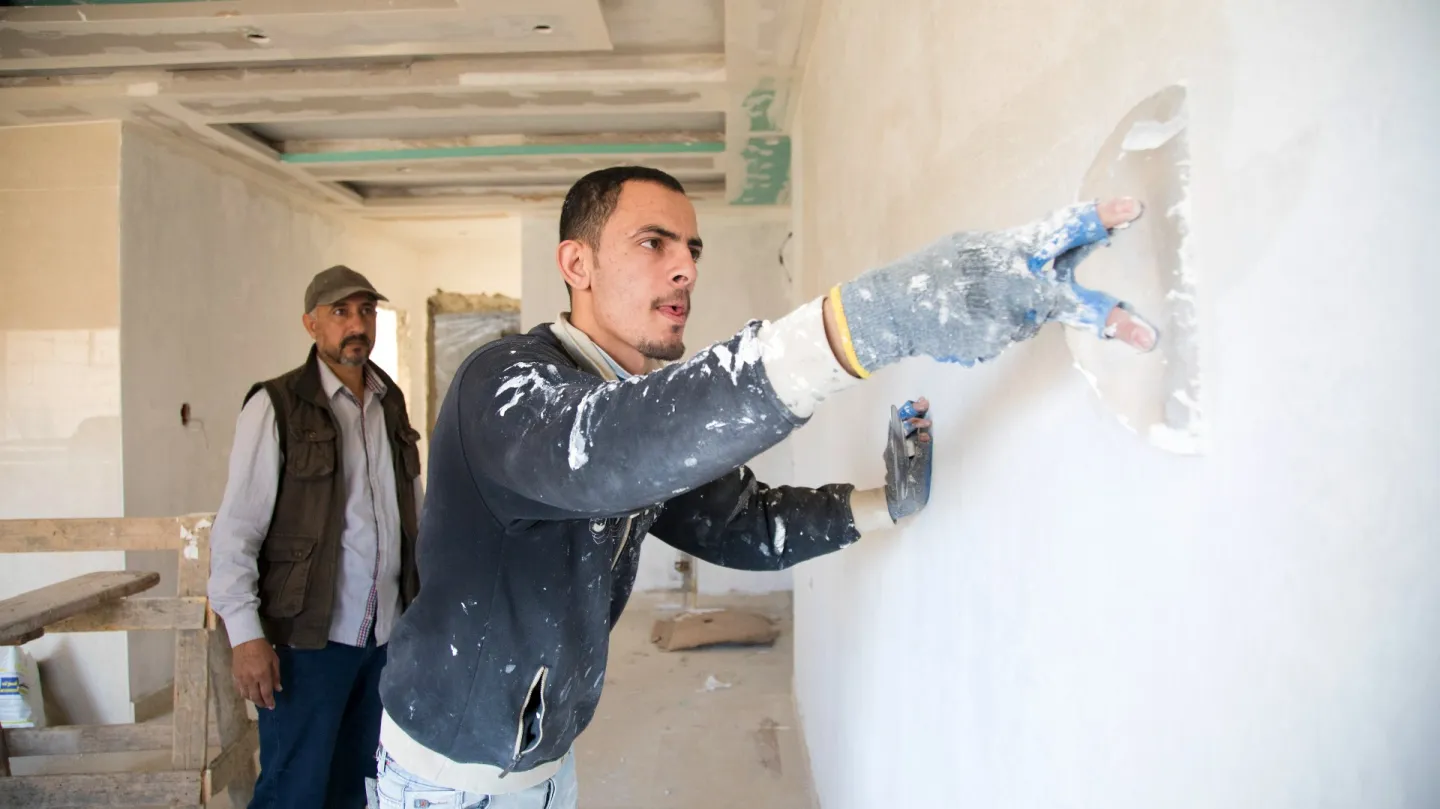 Ahmed Mohammed painting a wall