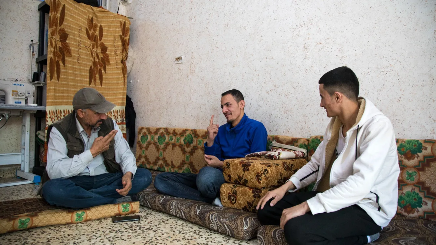 With the support from his father and brother, Ahmed is able to communicate during the trainings and work