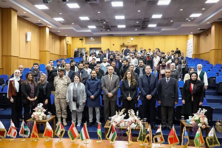 Jordanian and Syrian WBL-graduates are seen with officials from the ILO and implementing partners during their graduation ceremony in Jordan