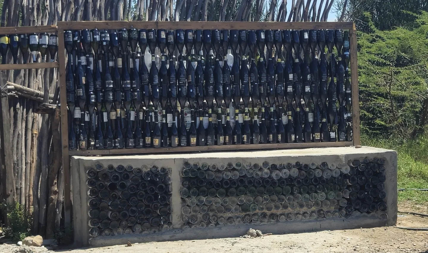A display of assorted pieces made from recycled glass embedded in a wooden frame.