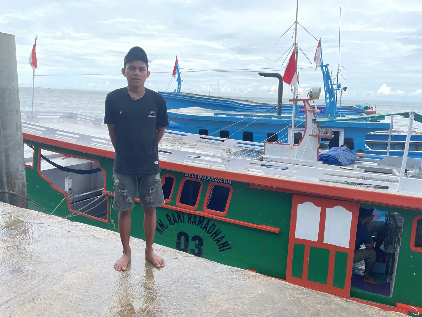 A young man standing on the port