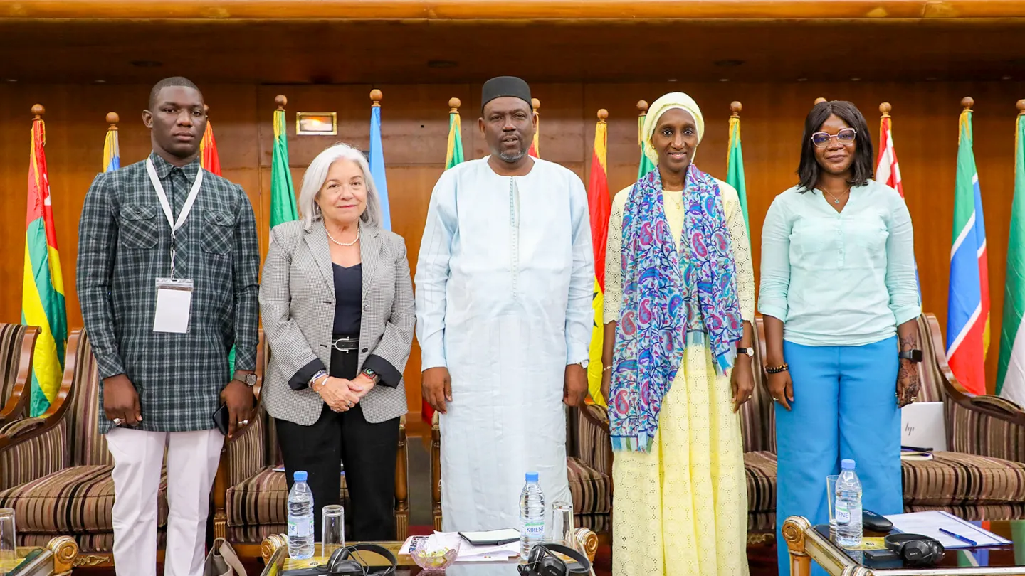 Opening speakers of the 4th West Africa and Sahel Youth Forum in Dakar: Assane Diallo, Barrie Freeman, and Dr. Coffi Agossou, addressing youth, jobs, education, and peace with national flags in the background.